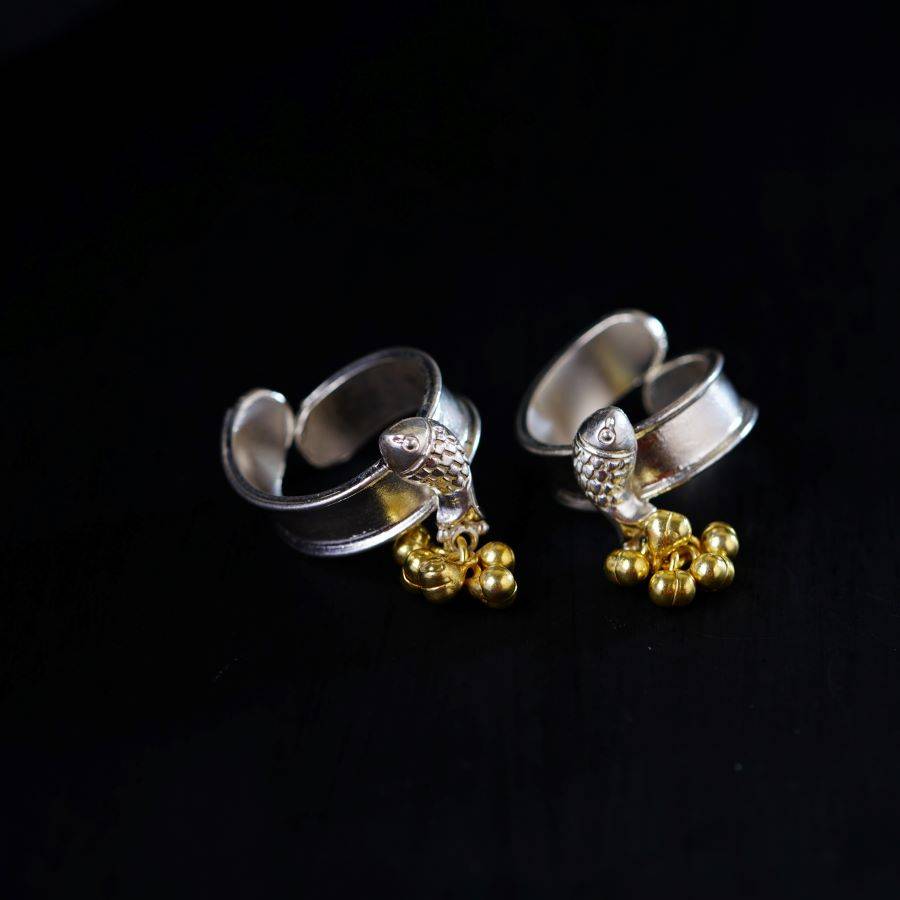 a pair of silver and gold earrings