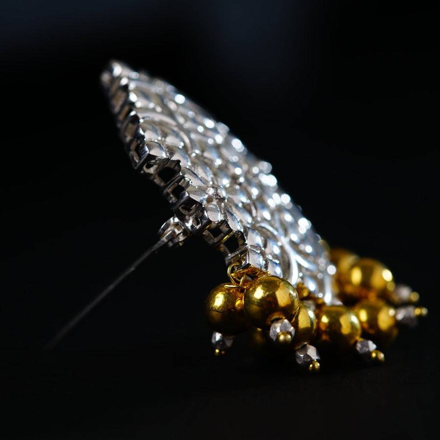 a close up of a metal object on a black surface