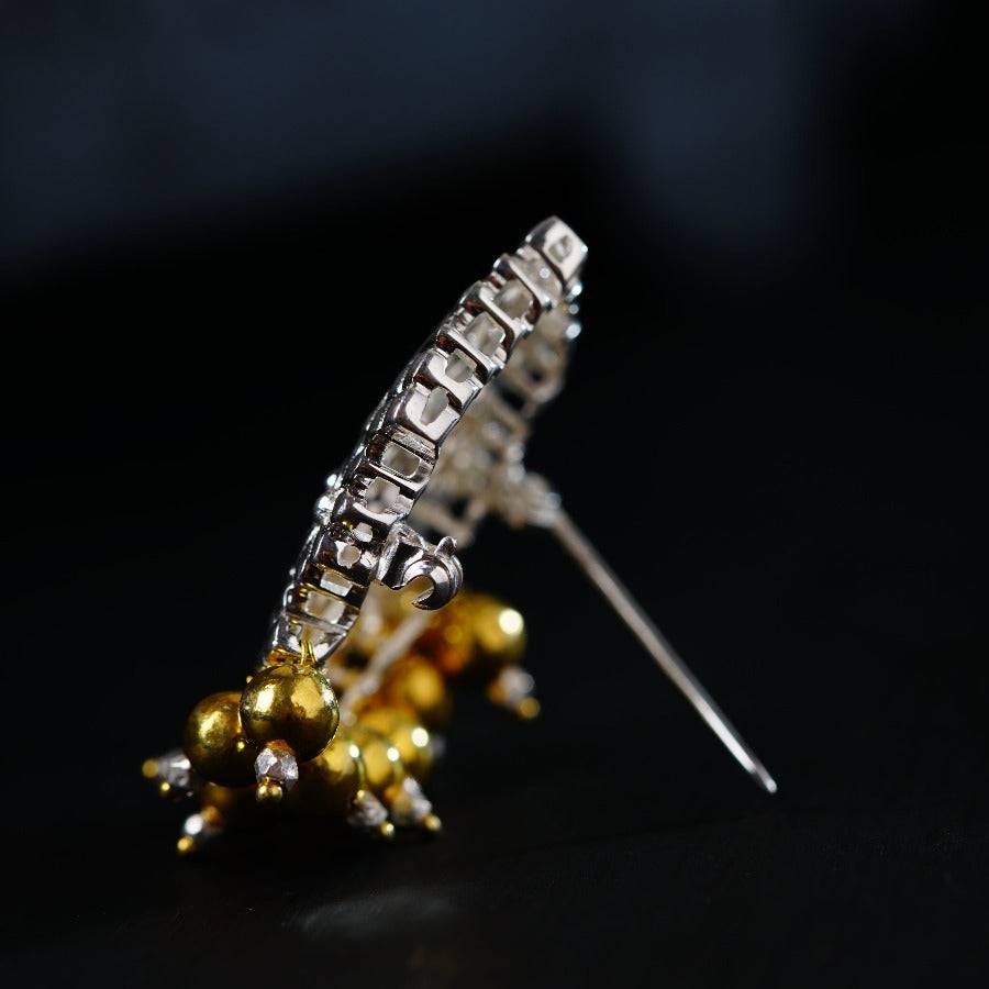 a close up of a brooch with beads