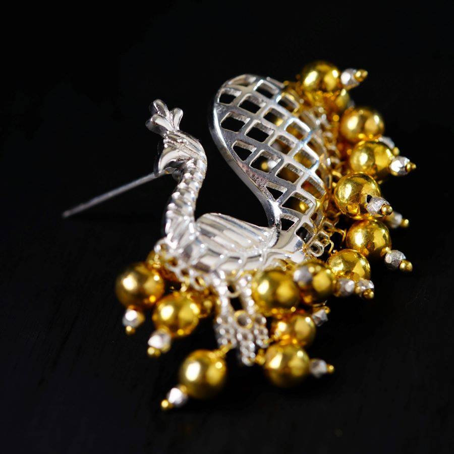 a close up of a brooch on a black surface