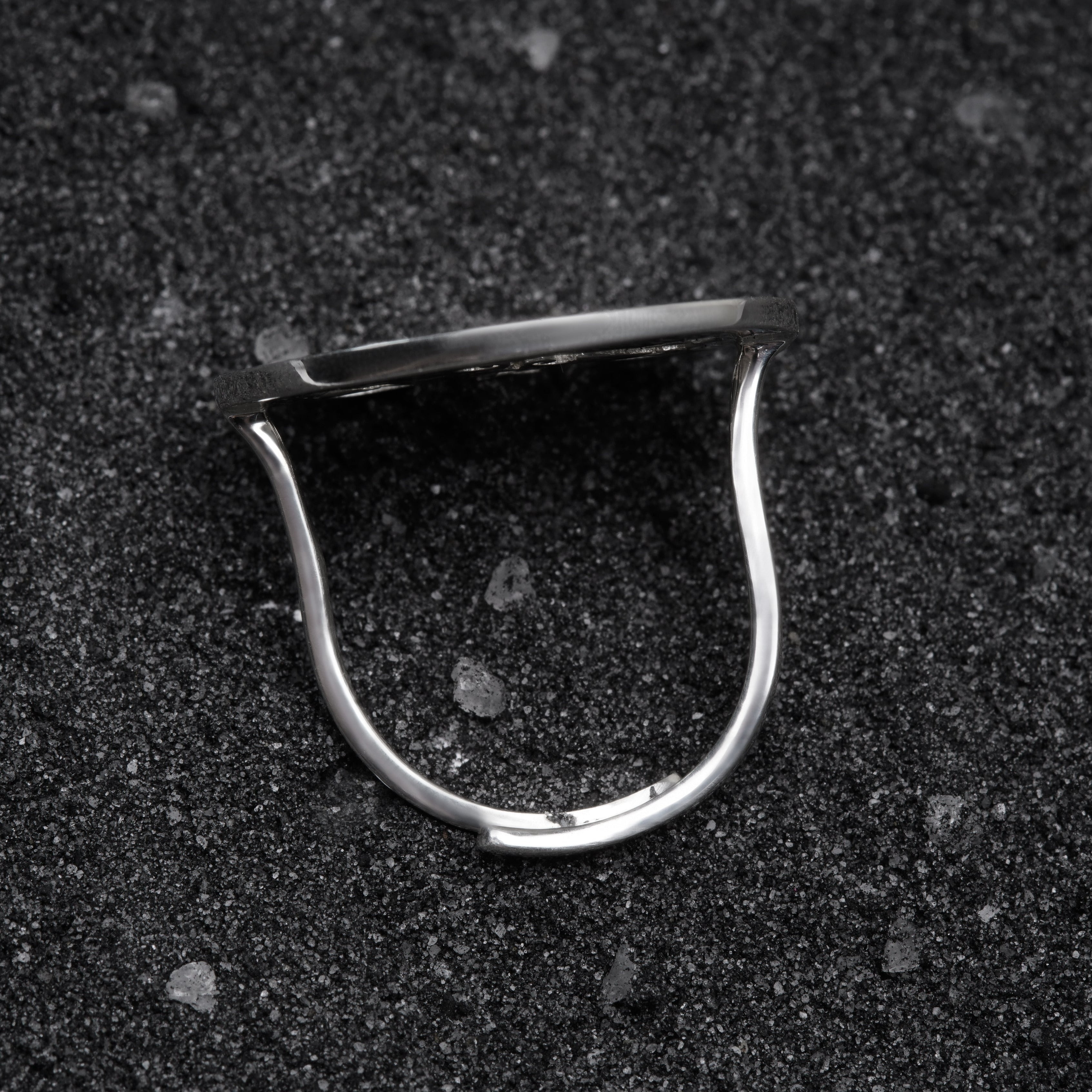 a close up of a metal object on a black surface