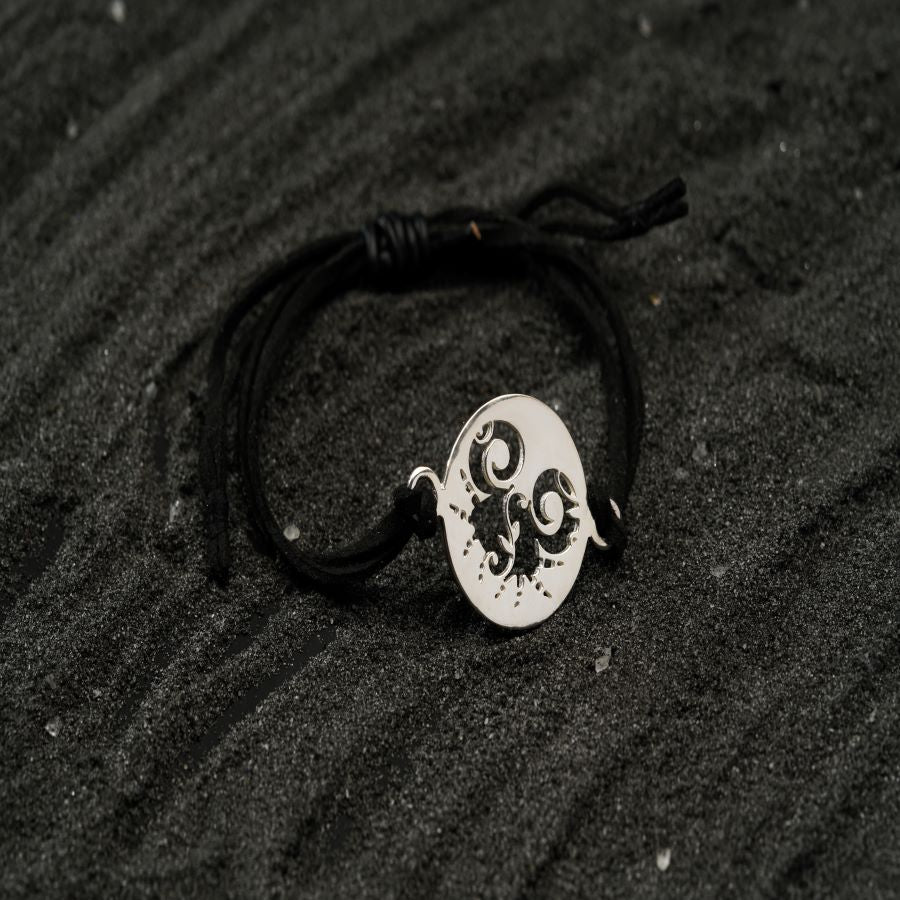 a black and white photo of a bracelet