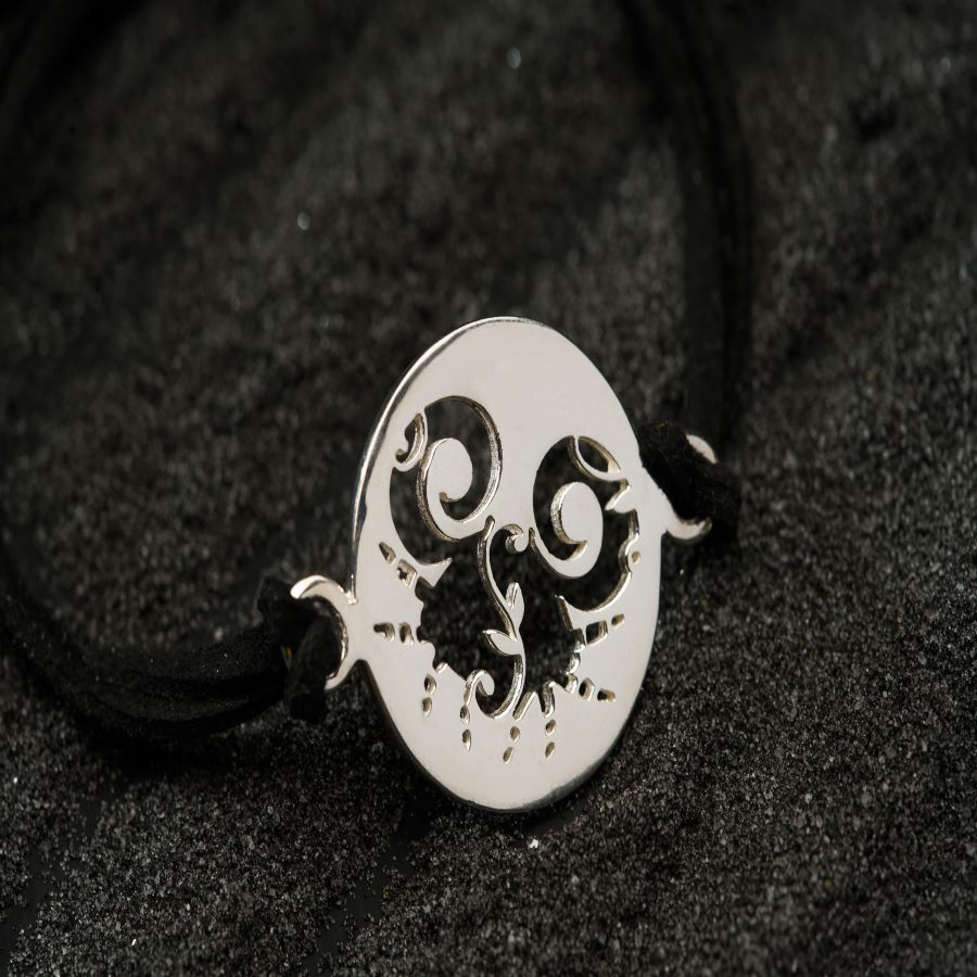 a silver necklace with a skull on it