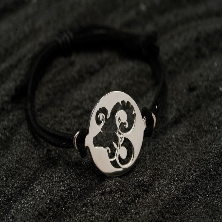 a black and white bracelet with a skull on it