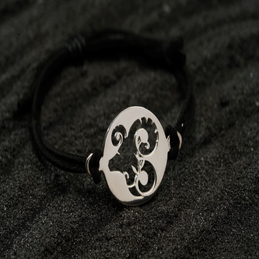 a black and white bracelet with a skull on it