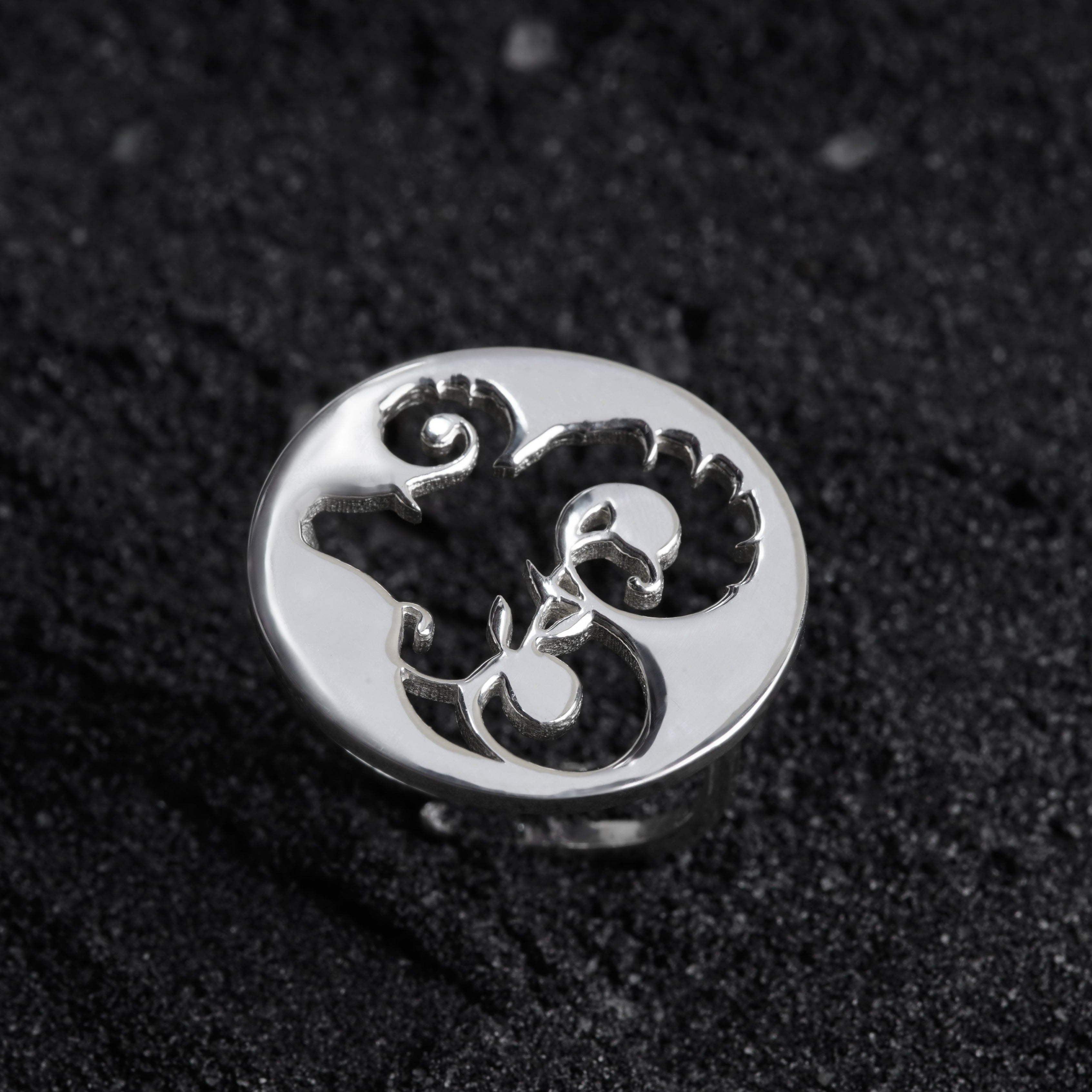 a close up of a ring on a black surface