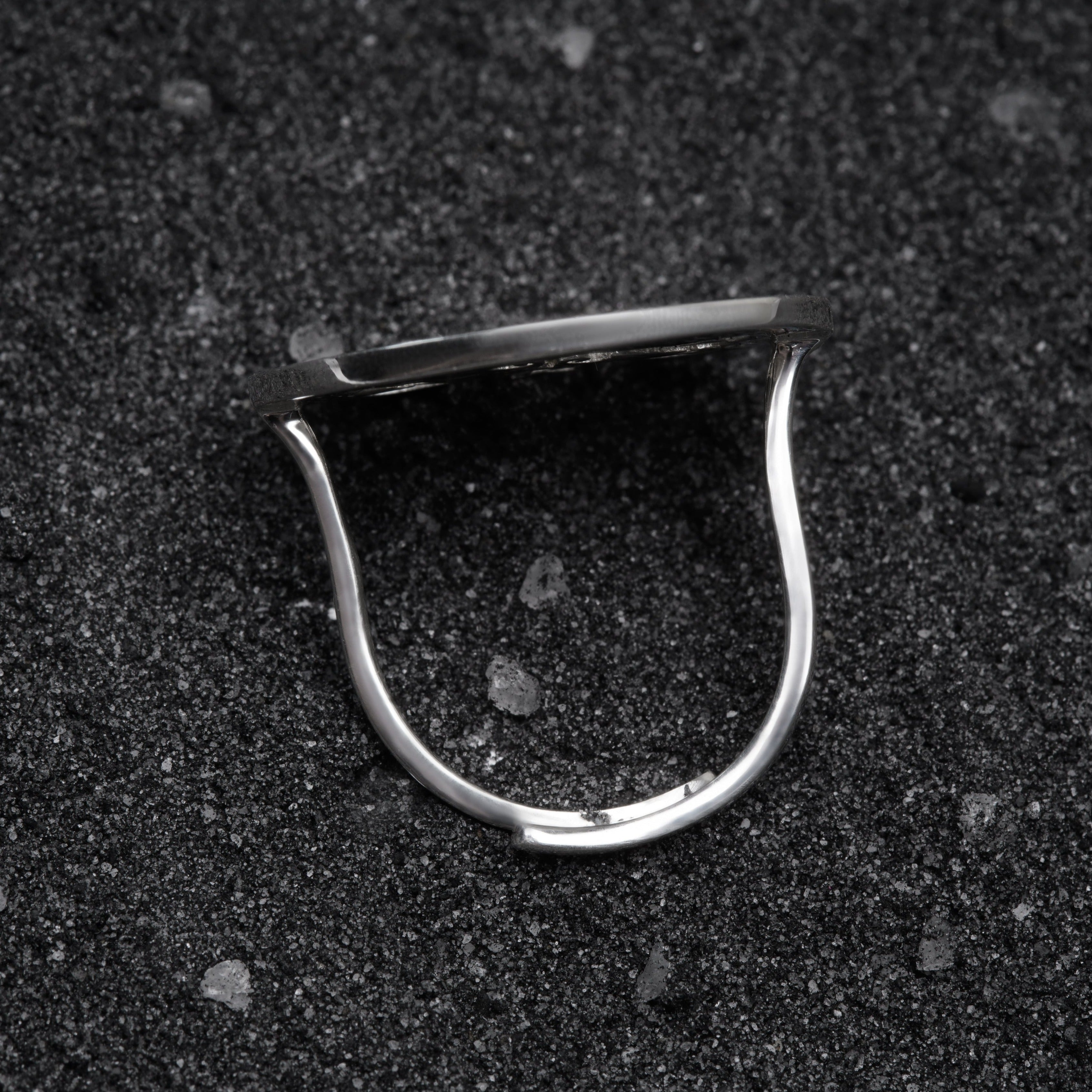 a close up of a metal object on a black surface