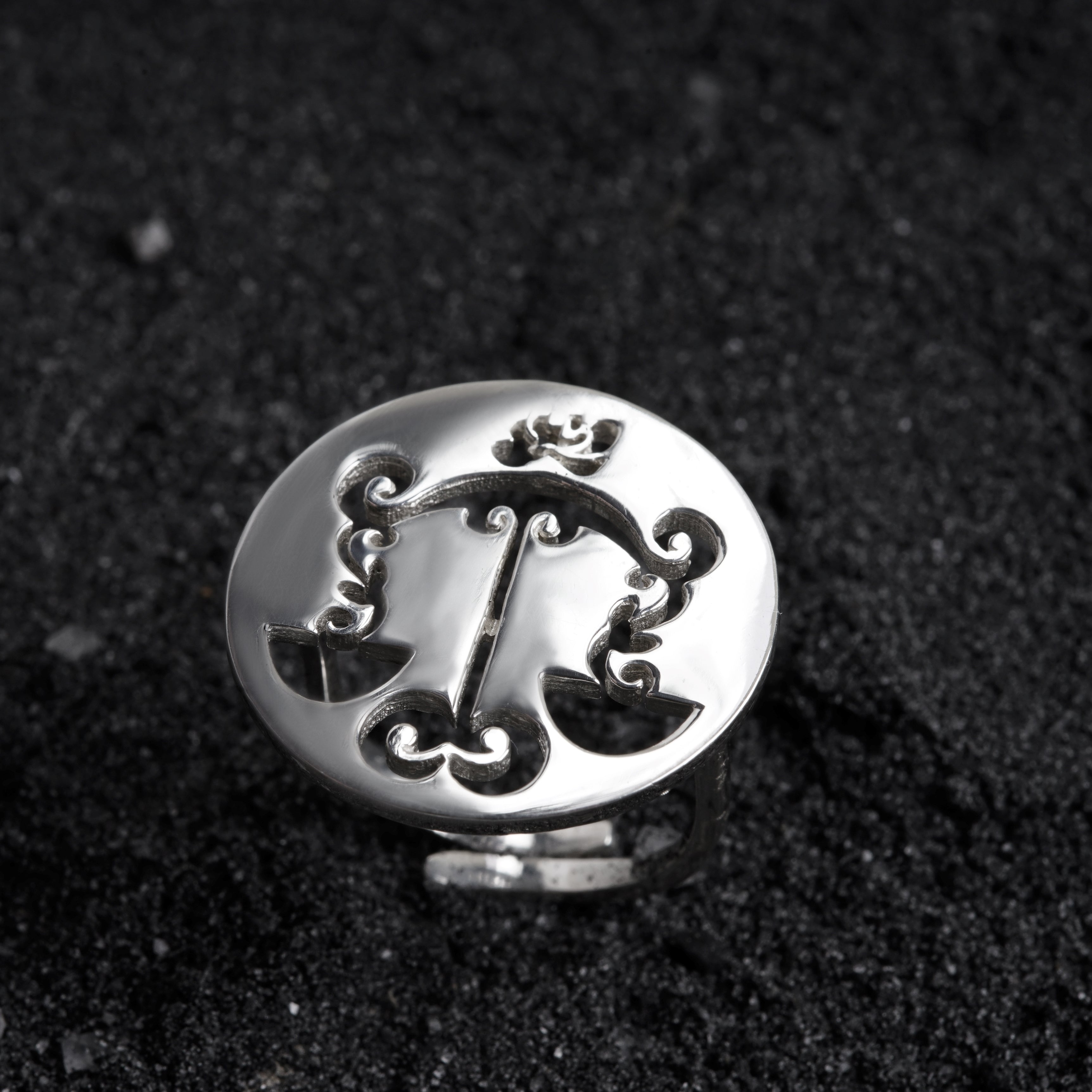 a close up of a metal object on a black surface