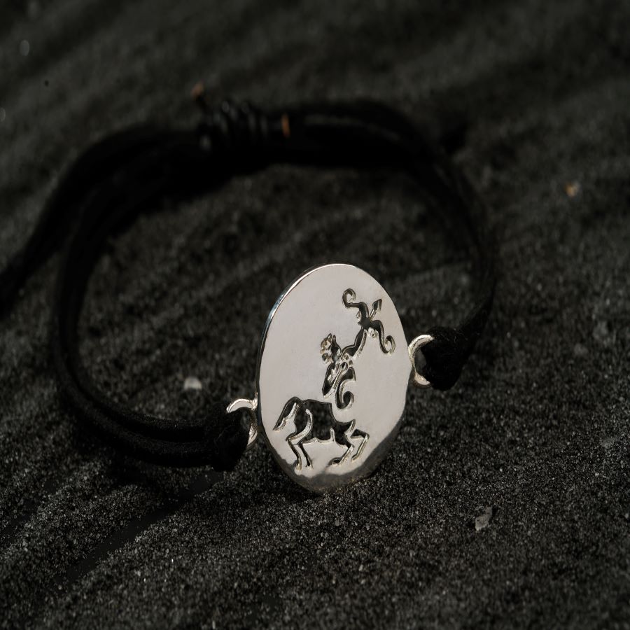 a silver bracelet with a horse on it