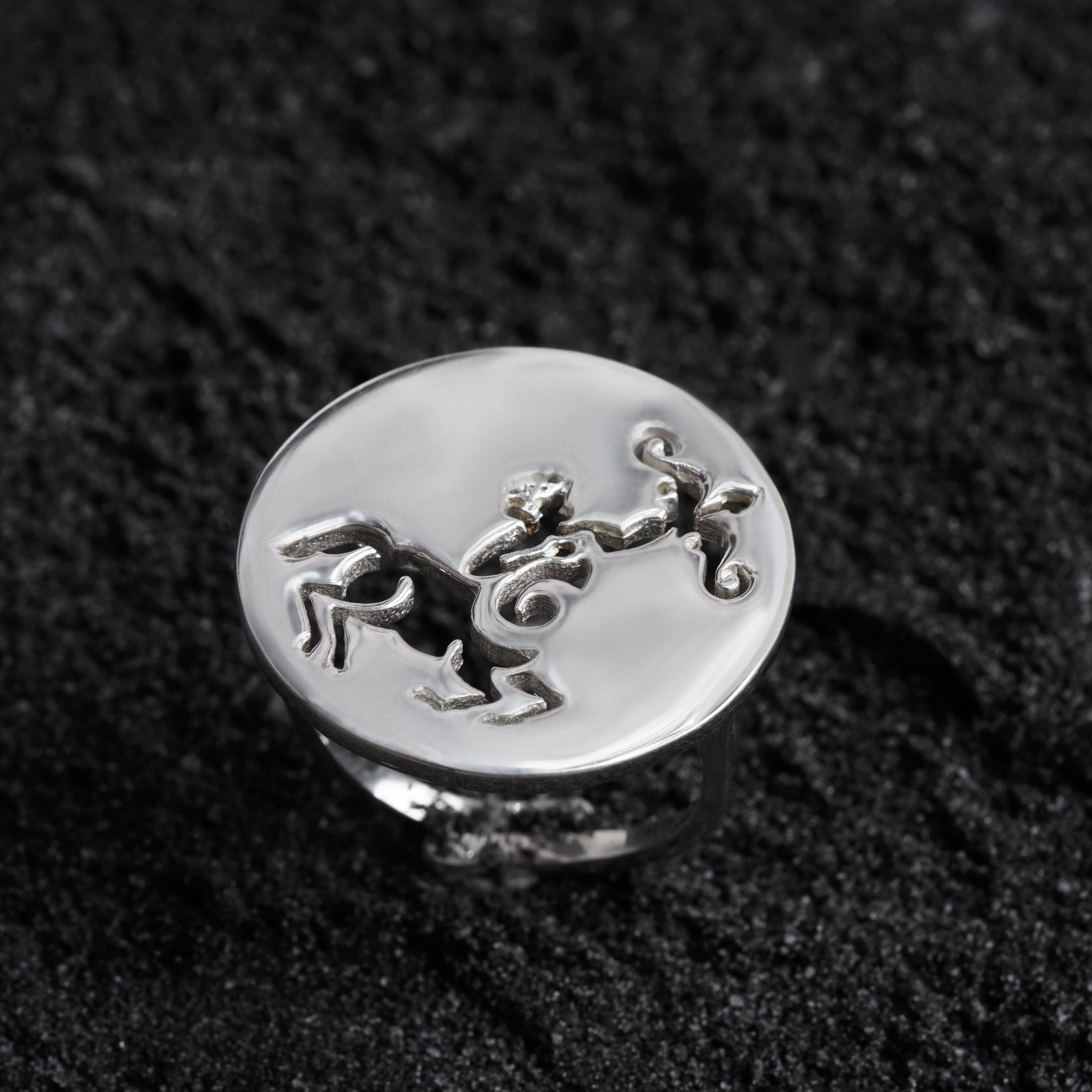 a silver ring with a horse on it