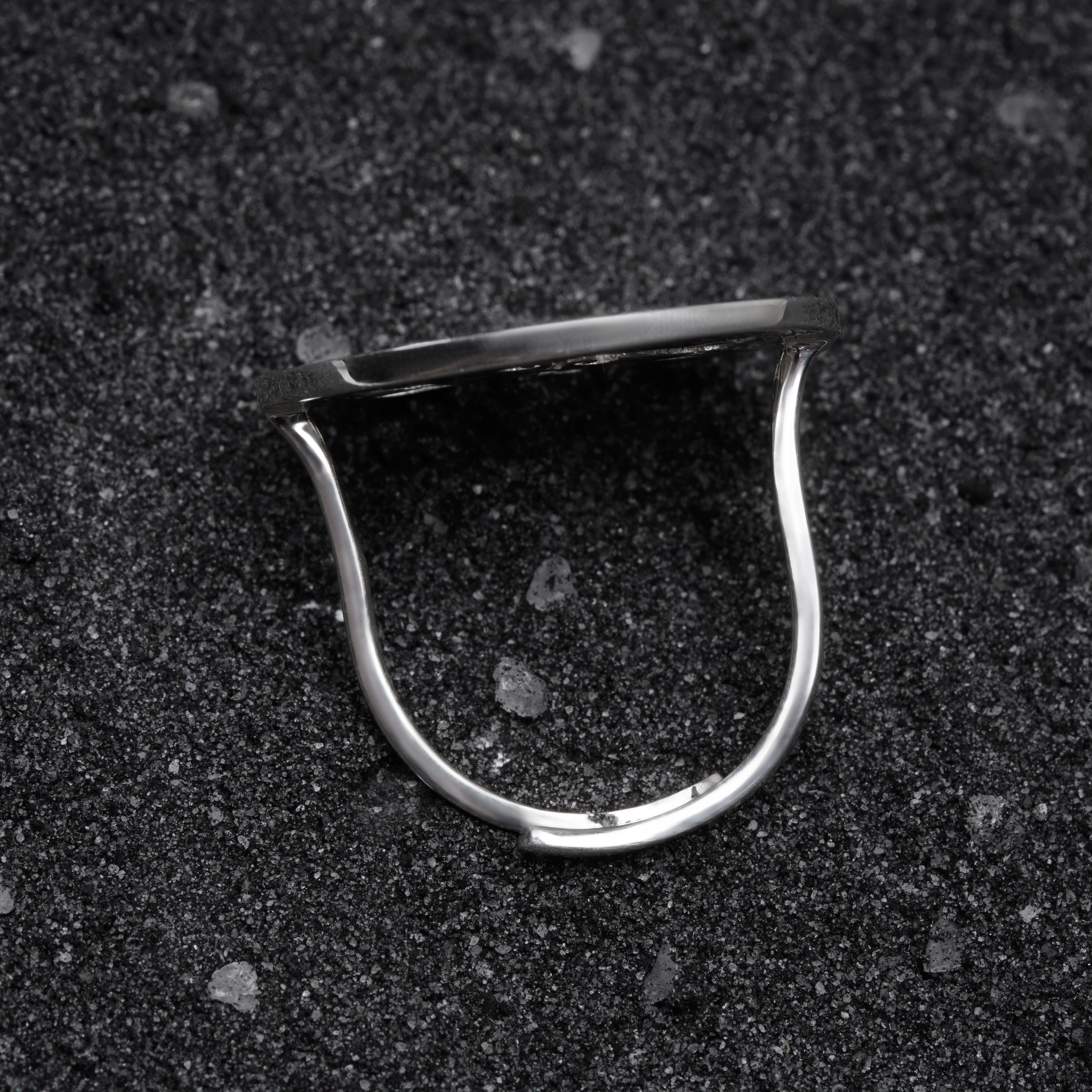 a close up of a metal object on a black surface