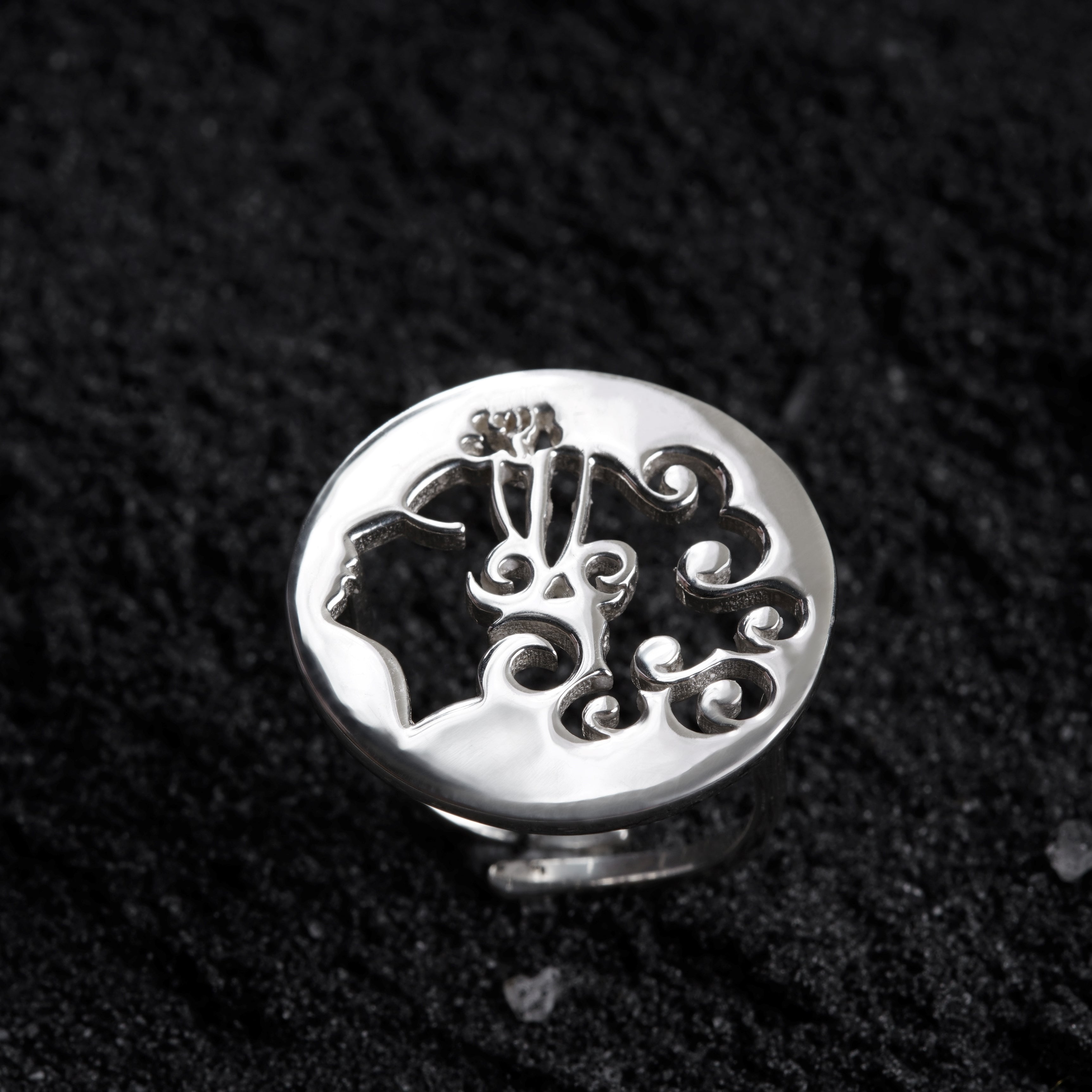 a close up of a ring on a black surface