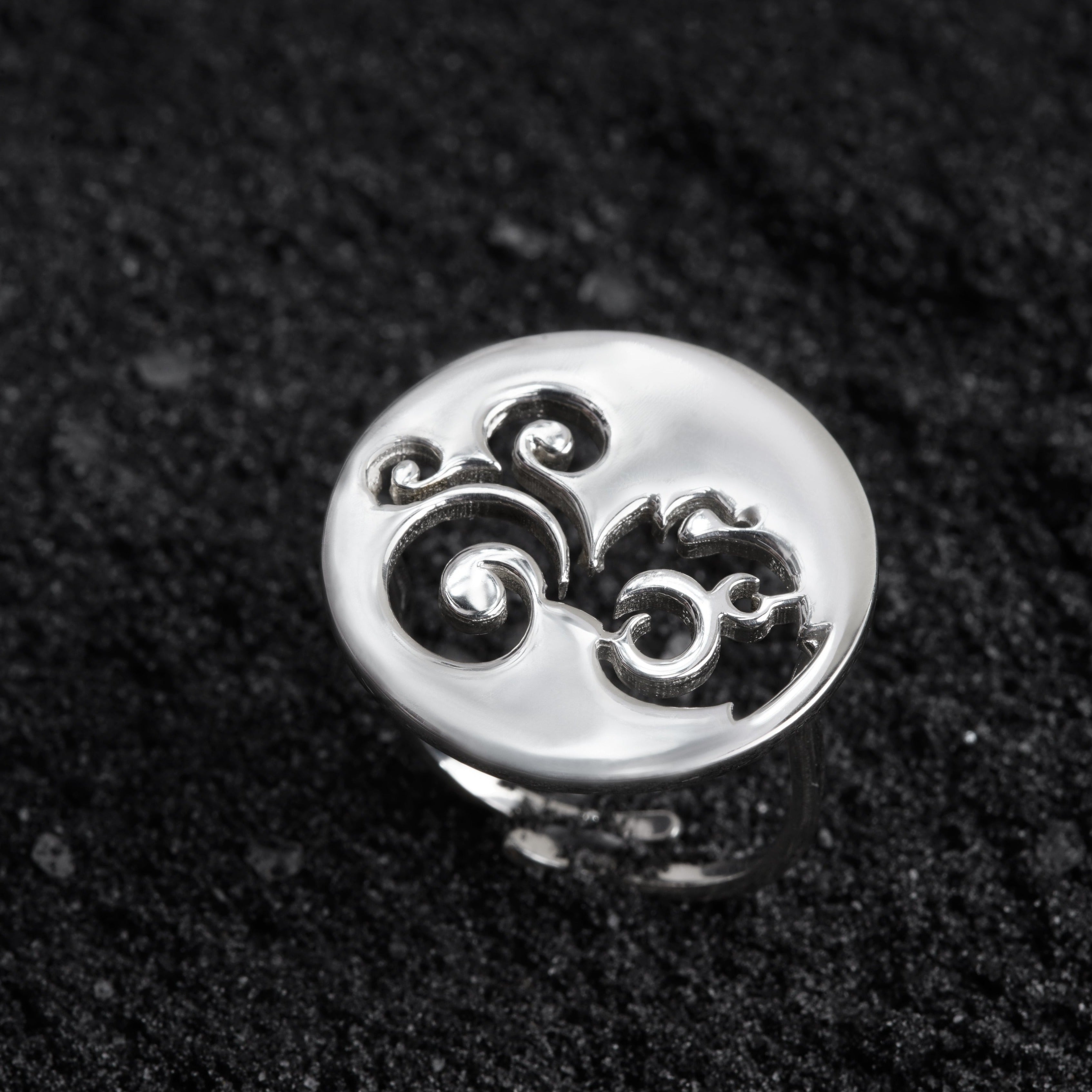 a close up of a ring on a black surface