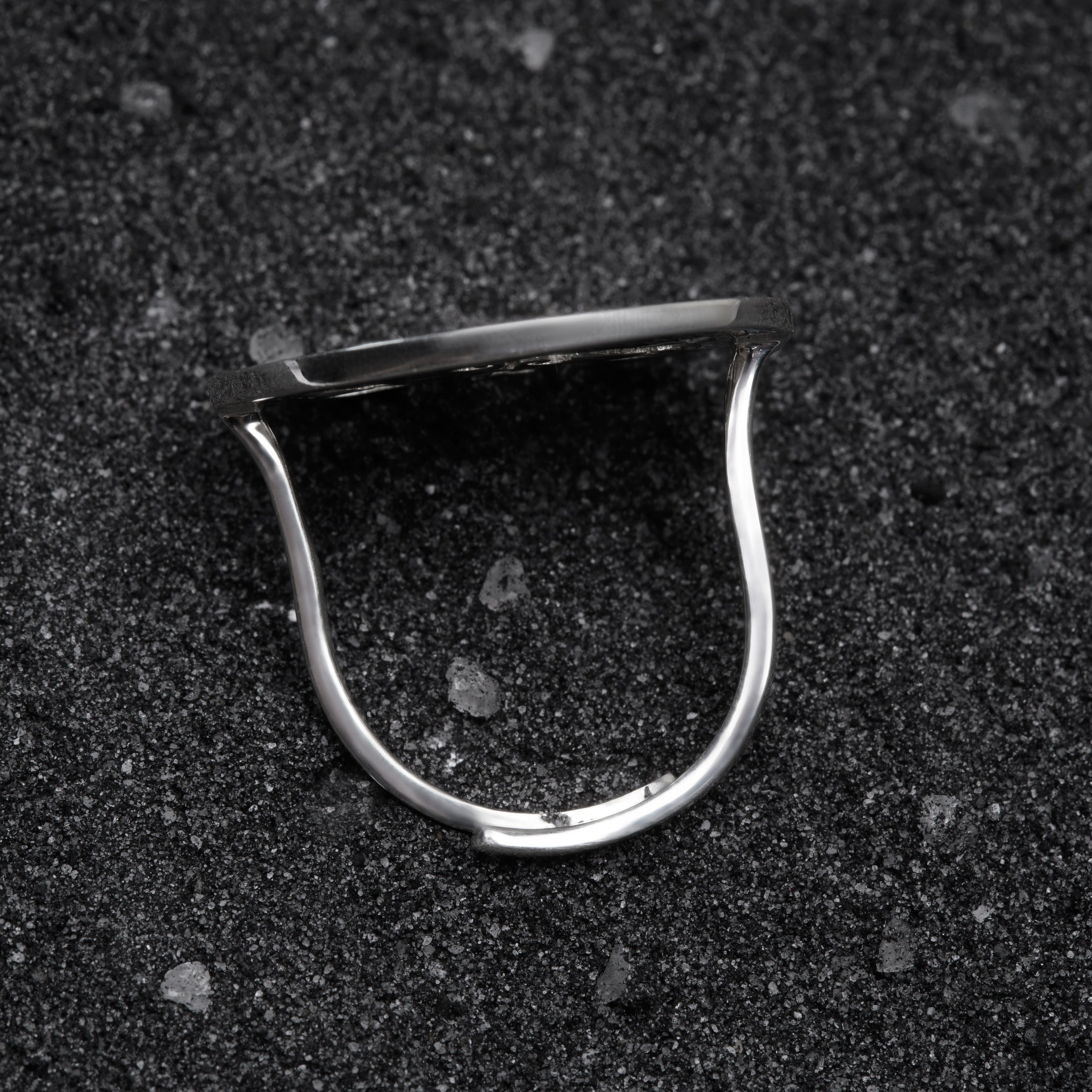 a close up of a metal object on a black surface