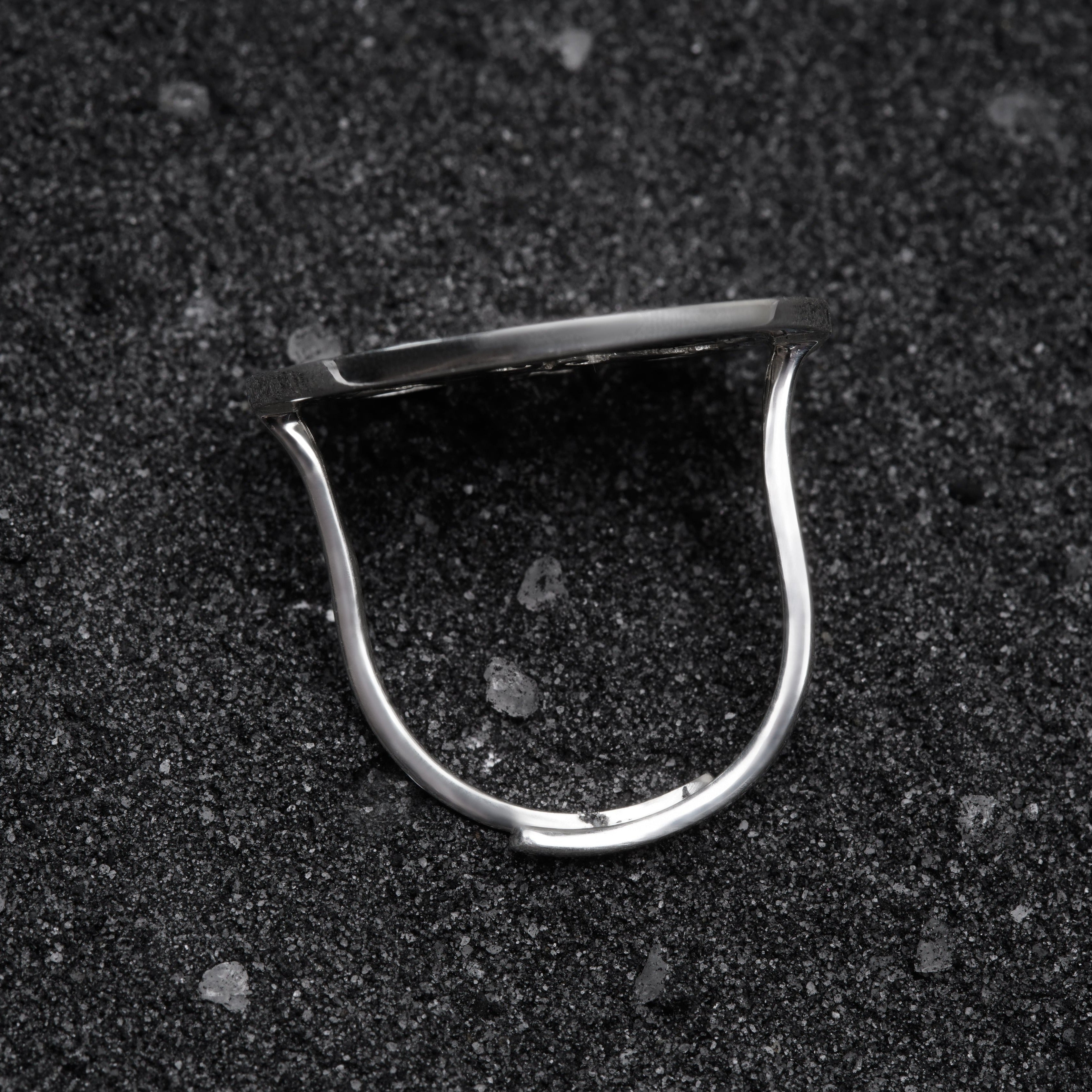 a close up of a metal object on a black surface