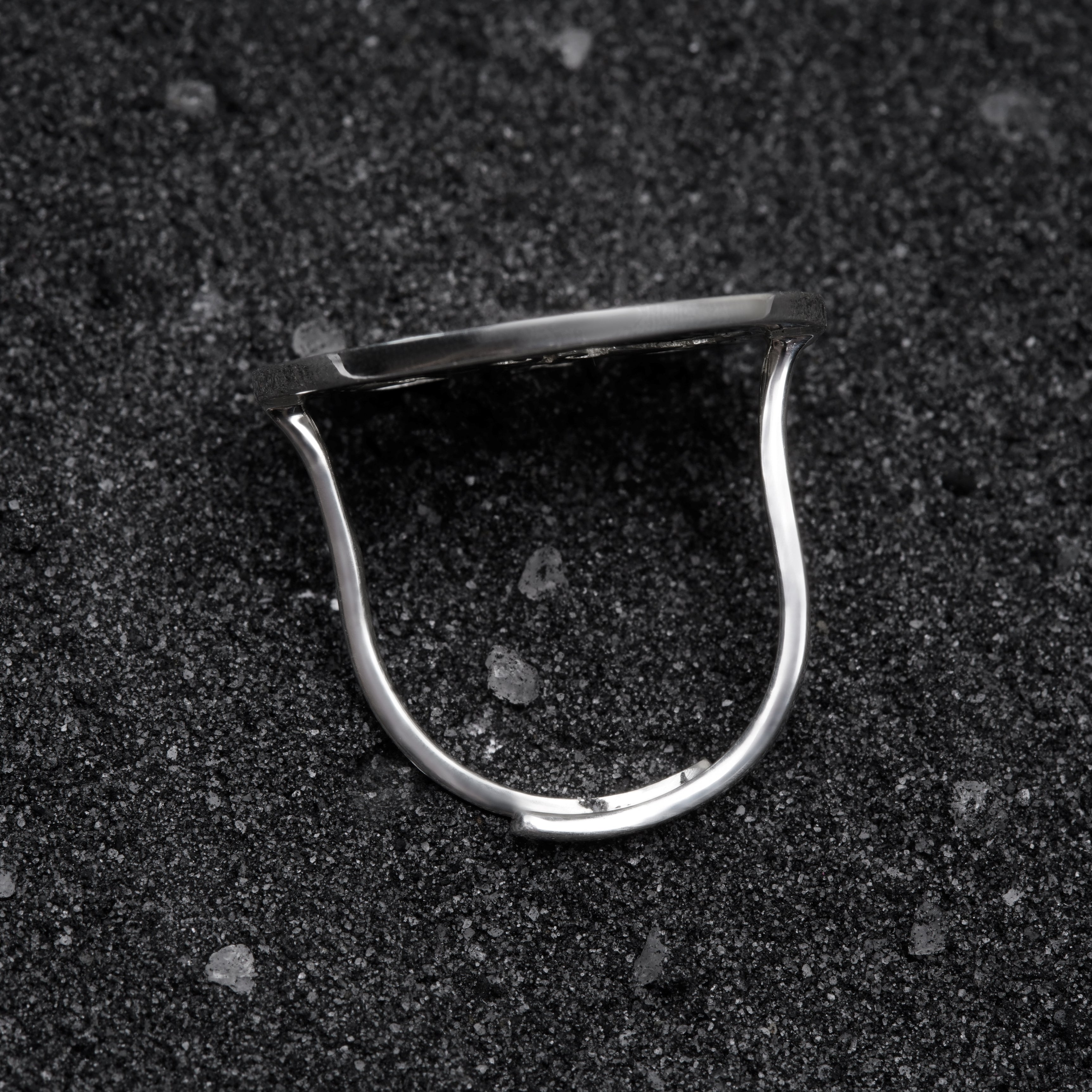 a close up of a metal object on a black surface
