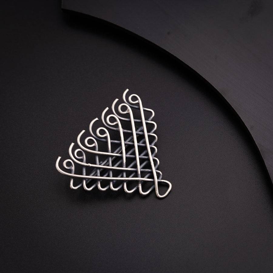 a metal object on a black surface next to a knife