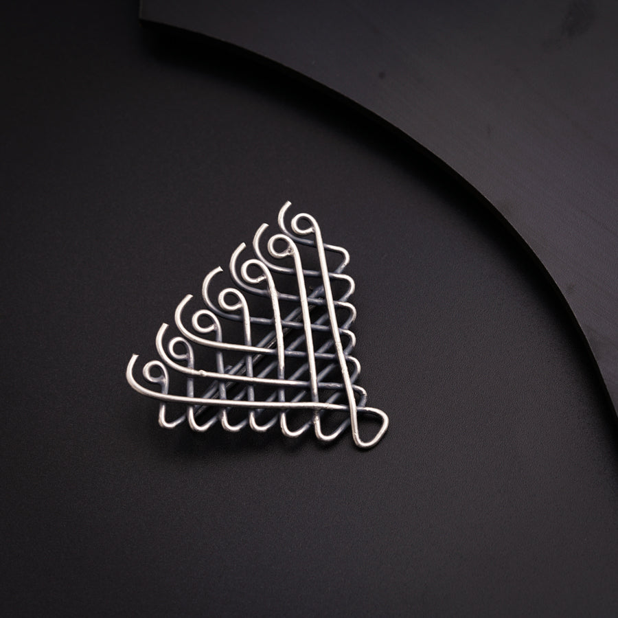 a metal object on a black surface next to a knife