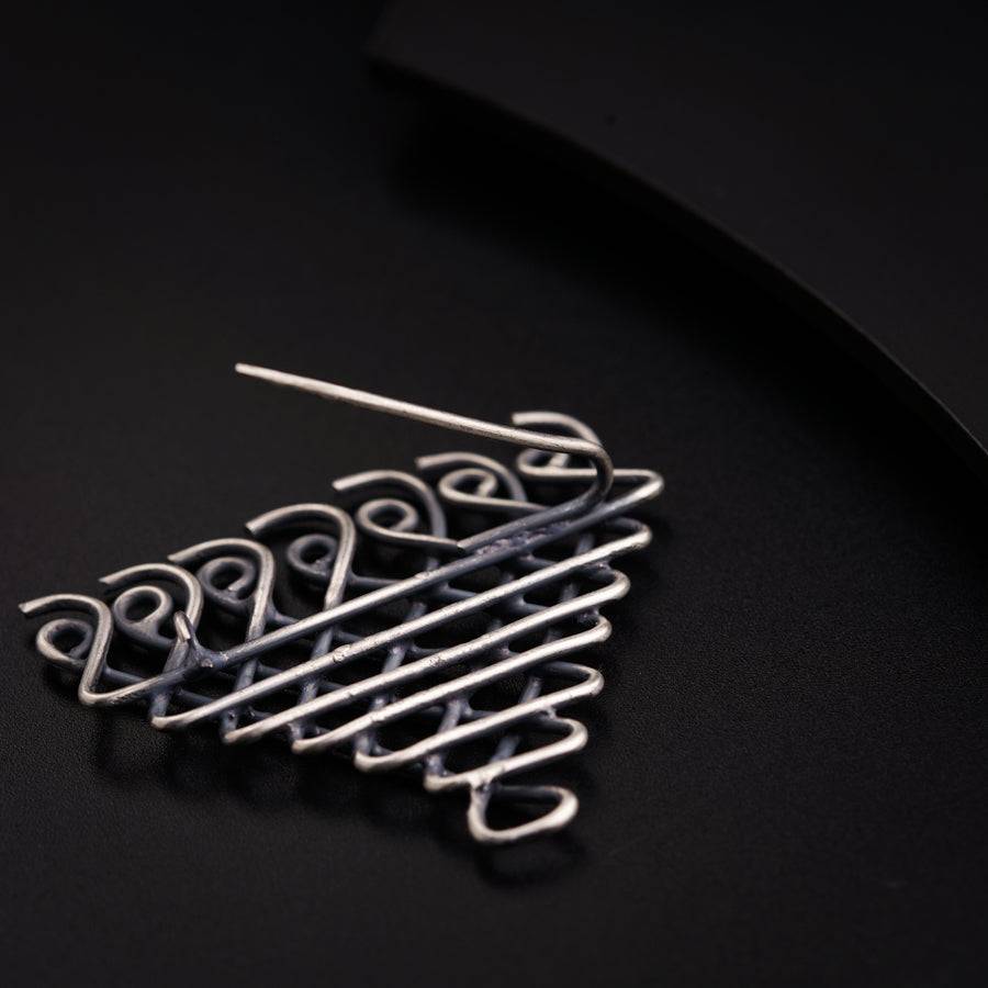 a close up of a metal object on a black surface