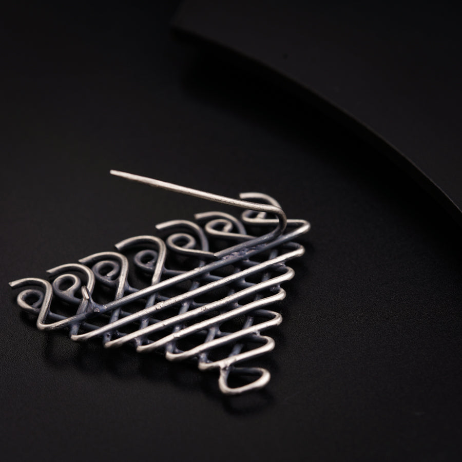 a close up of a metal object on a black surface