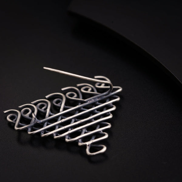 a close up of a metal object on a black surface