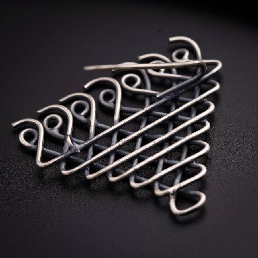 a close up of a metal object on a black surface