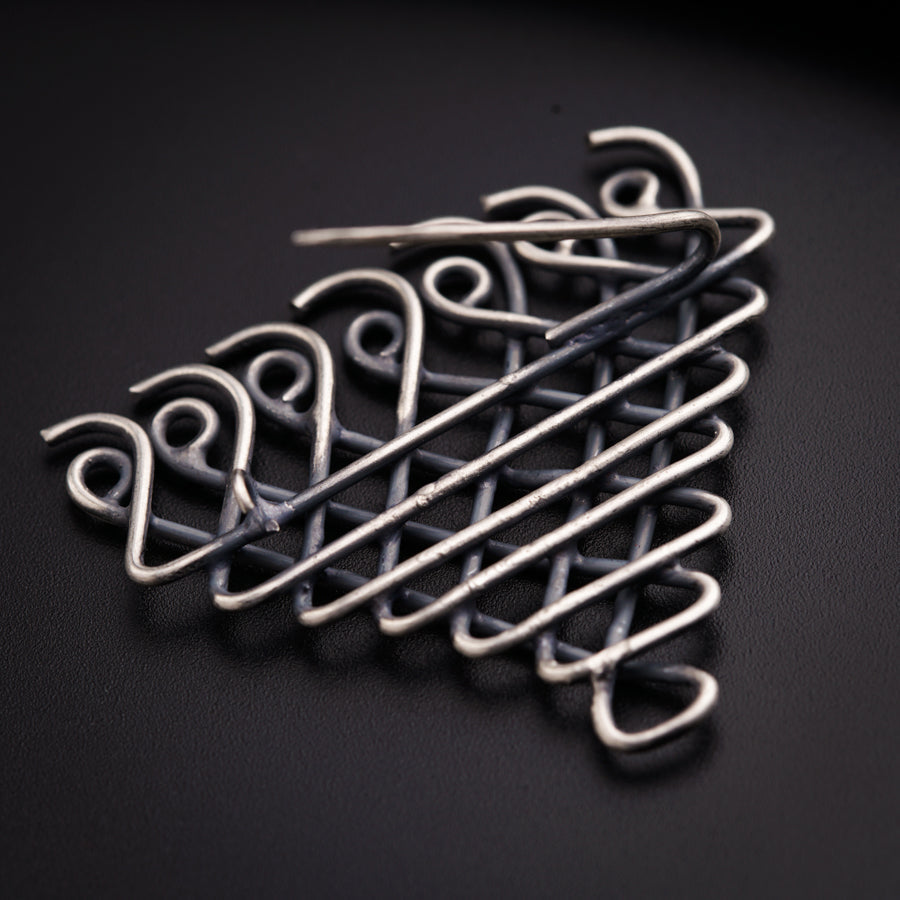 a close up of a metal object on a black surface