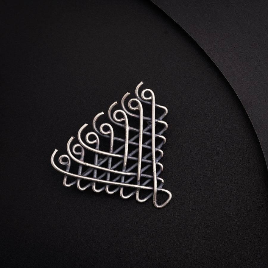 a metal object on a black surface