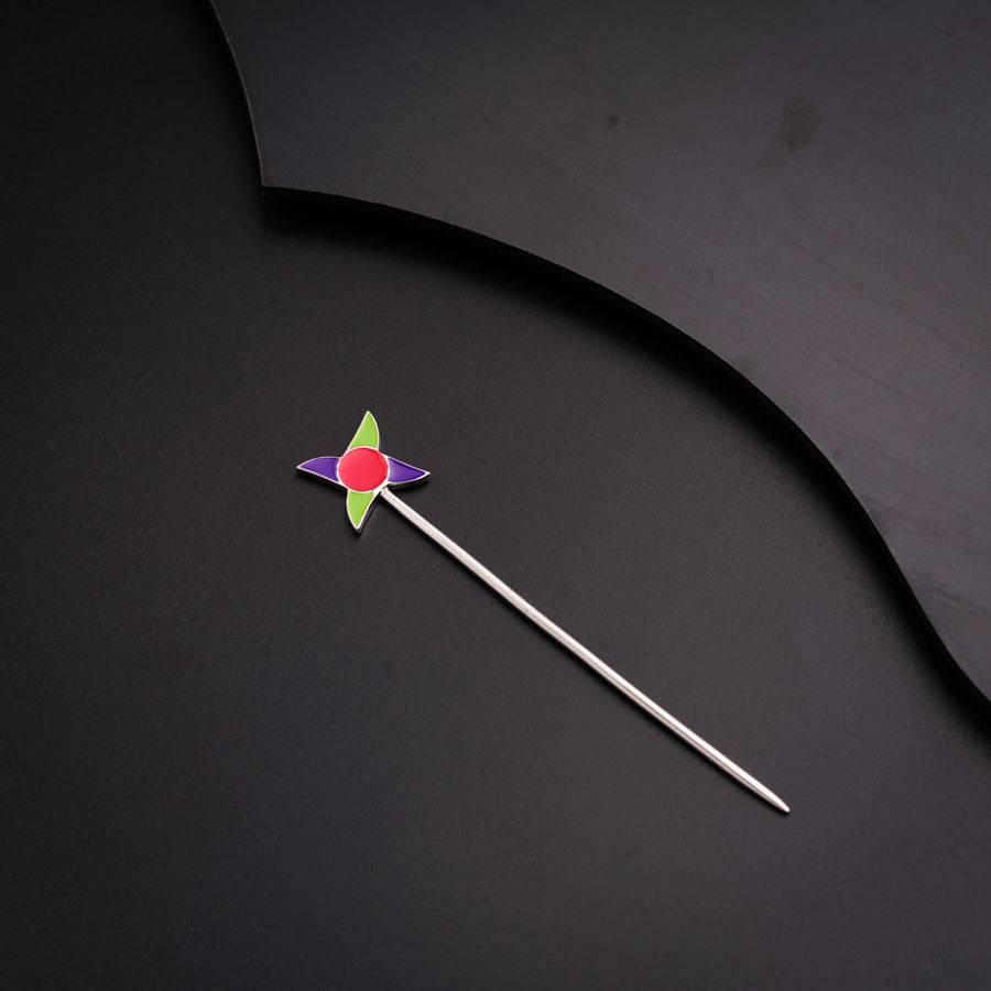 a pin with a star on it on a black surface