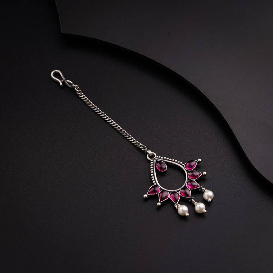 a close up of a necklace on a black surface