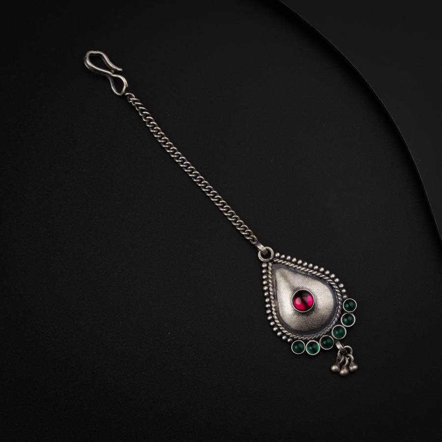 a close up of a necklace on a black surface