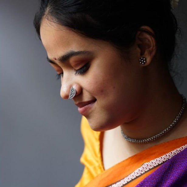 a woman with a nose ring and a necklace