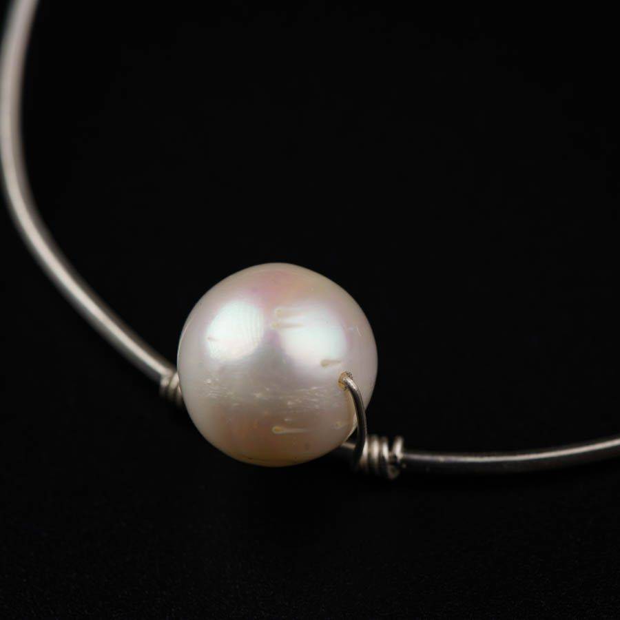 a close up of a white pearl on a black background