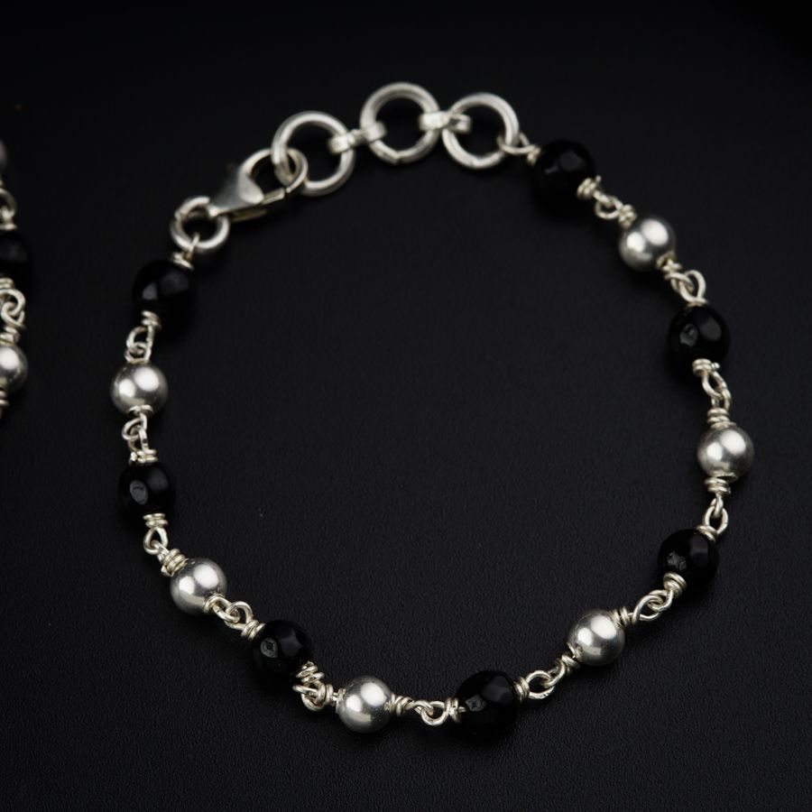a black and white bracelet with silver beads