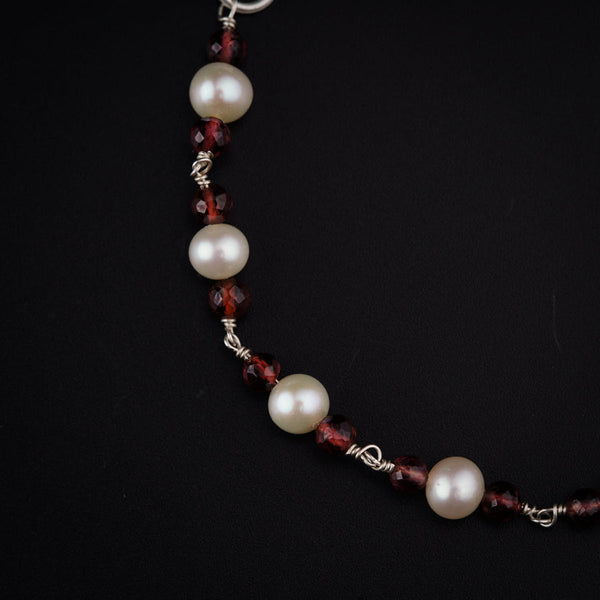 a close up of a necklace on a black background