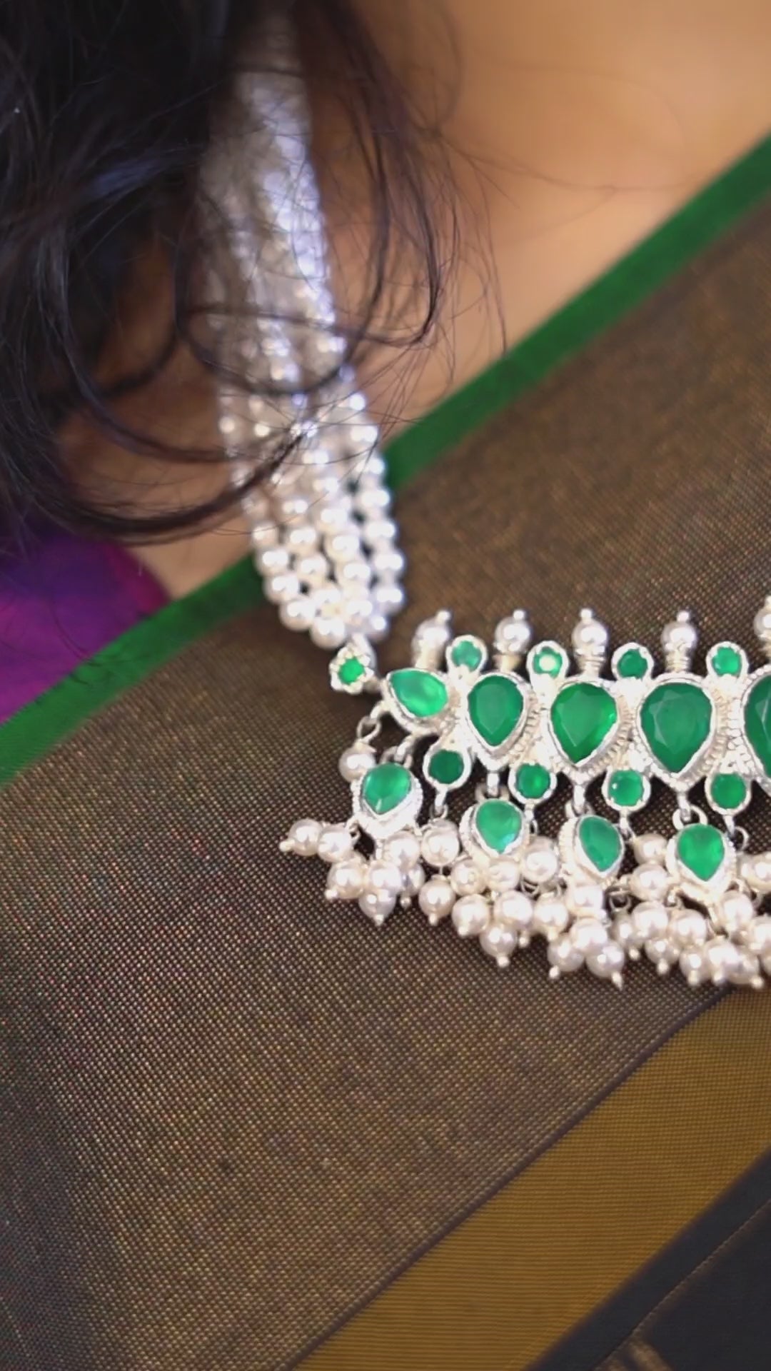 a close up of a green and white necklace