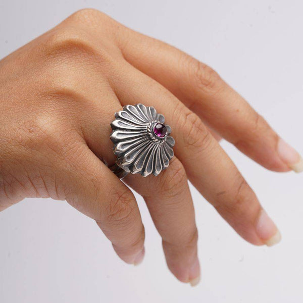 a woman's hand with a ring on it