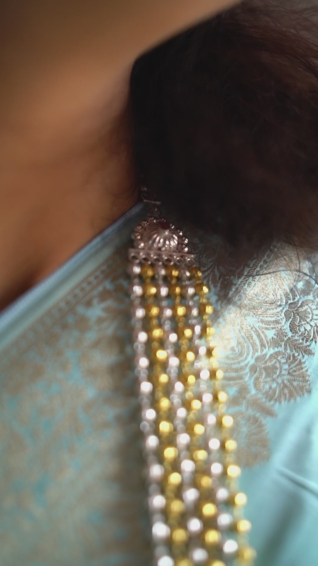 a close up of a woman wearing a necklace