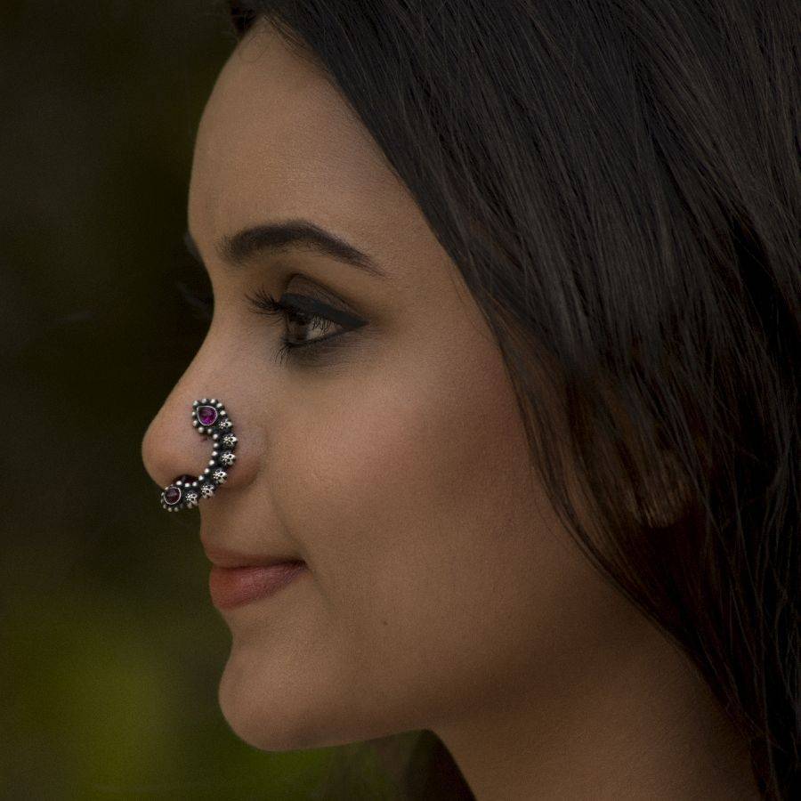 a close up of a woman with a nose piercing
