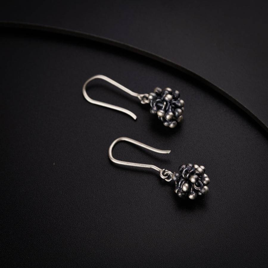 a pair of earrings sitting on top of a table