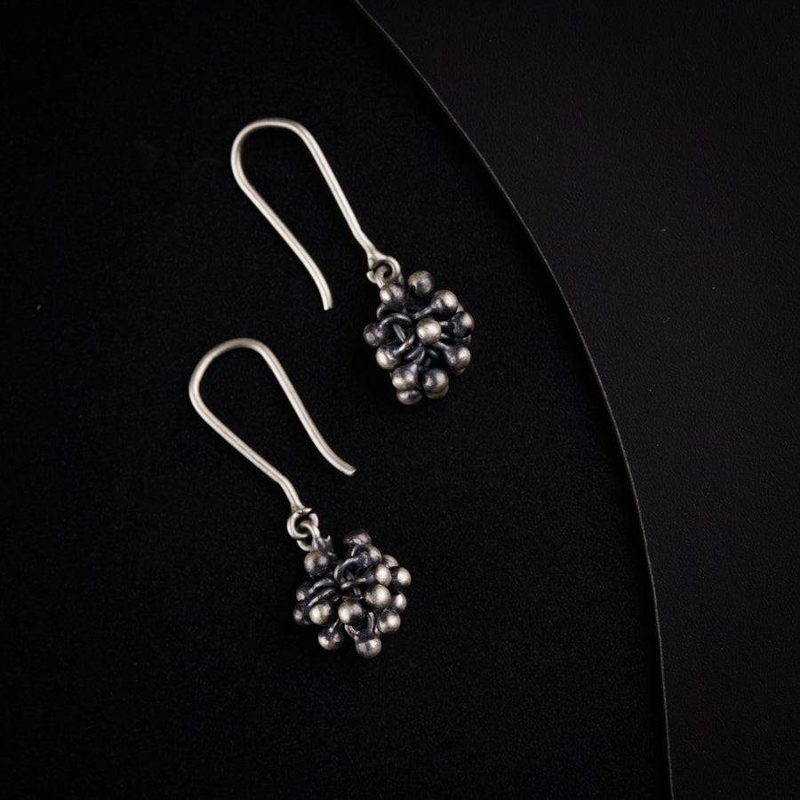 a pair of earrings sitting on top of a table