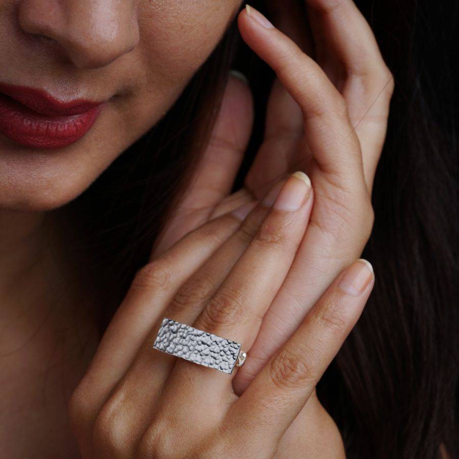 a close up of a person wearing a ring