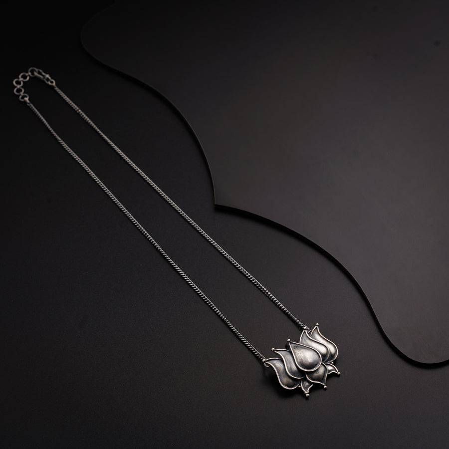a silver necklace with a horse on it