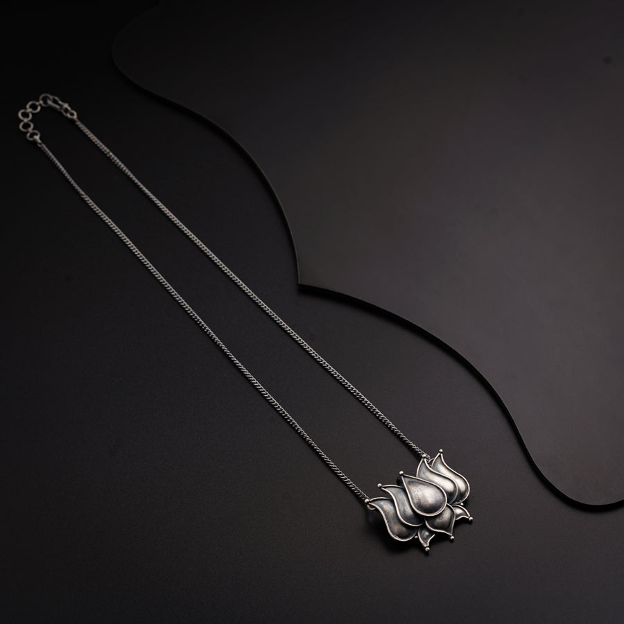 a silver necklace with a cat on it