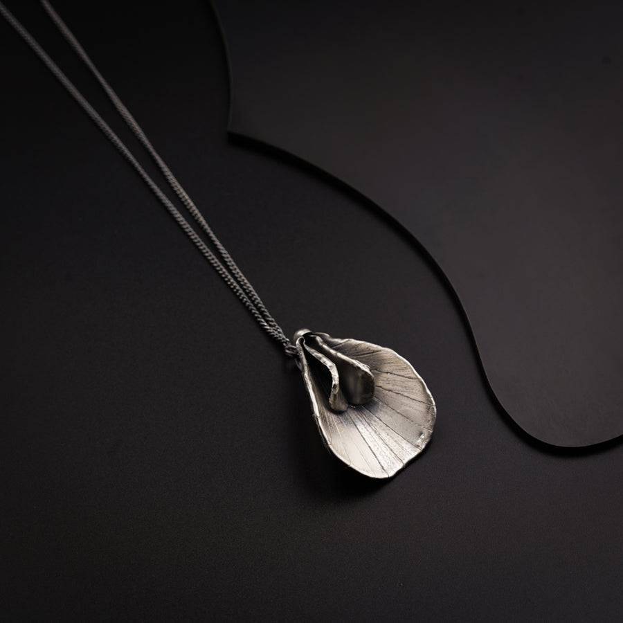 a close up of a necklace on a black surface
