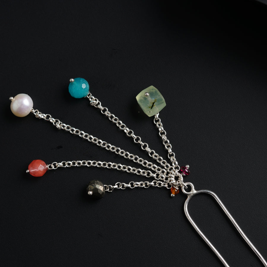 a bunch of different colored beads on a chain