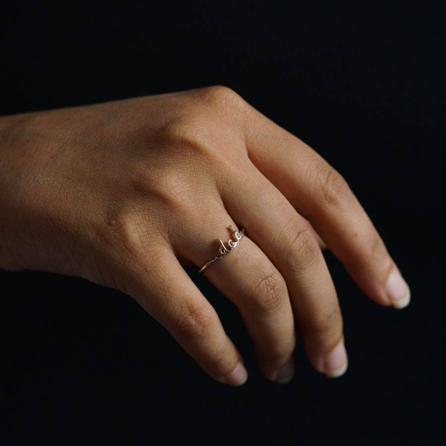 a woman's hand with a diamond ring on it
