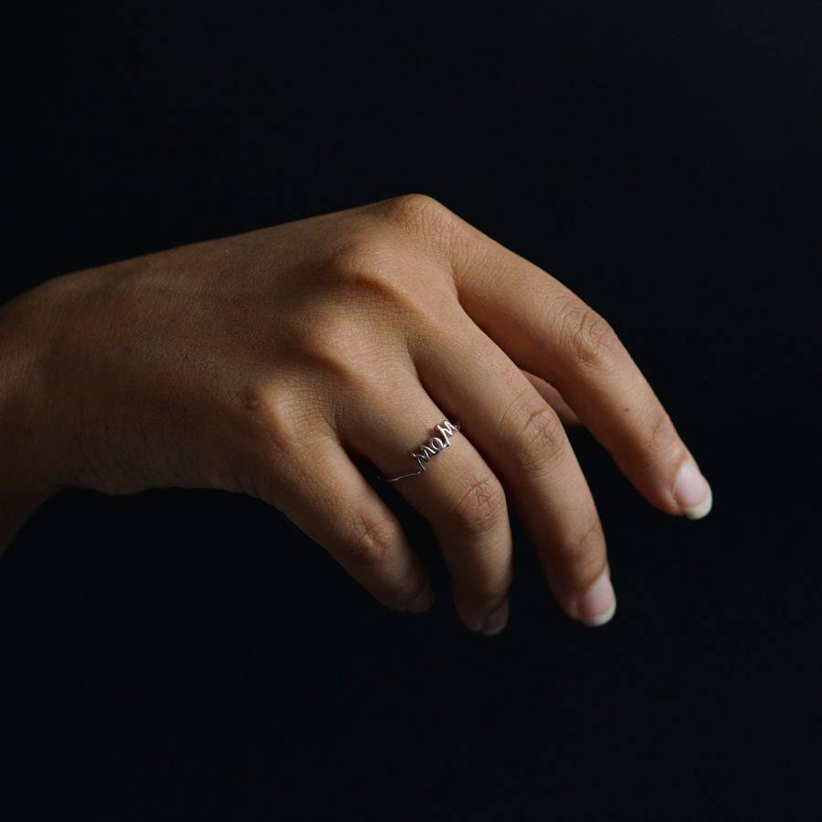 a woman's hand with a diamond ring on it