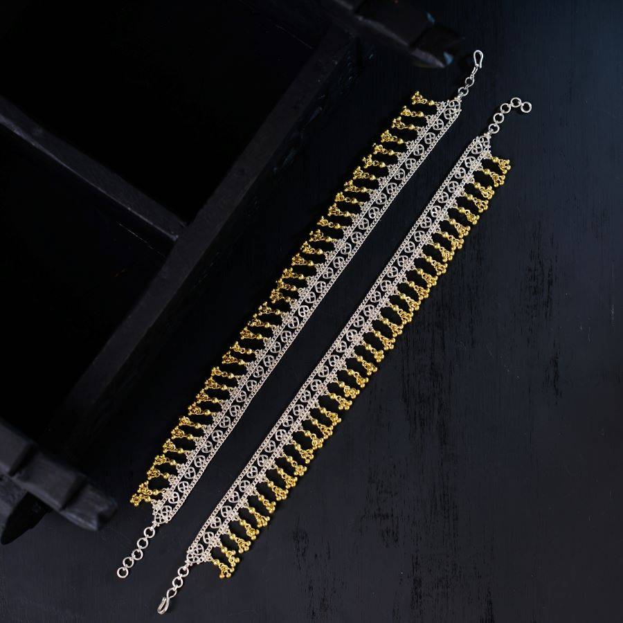 a pair of gold and silver chain bracelets