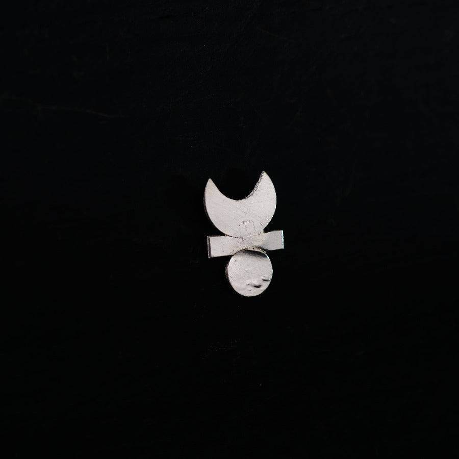 a metal object with a bow on a black background
